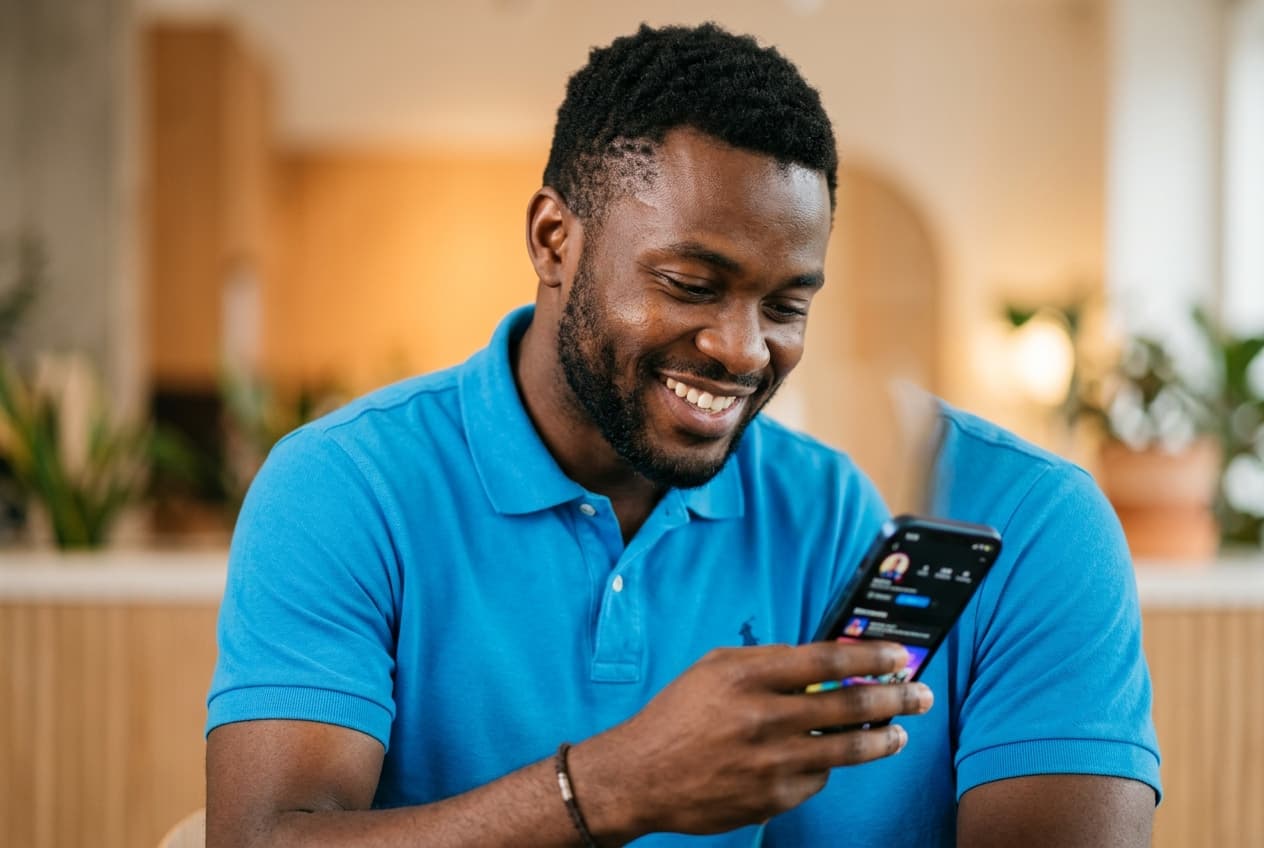 Freelancer using smartphone and smiling